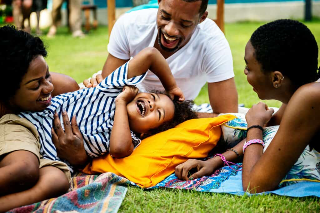 pais e filhos brincando ao ar livre comemorando o dia internacional da família